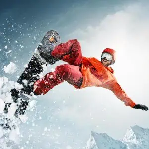 Snowboarder jumping through air with deep blue sky in background. The snowboard, snow, winter, extreme, snowboarding, sport concept